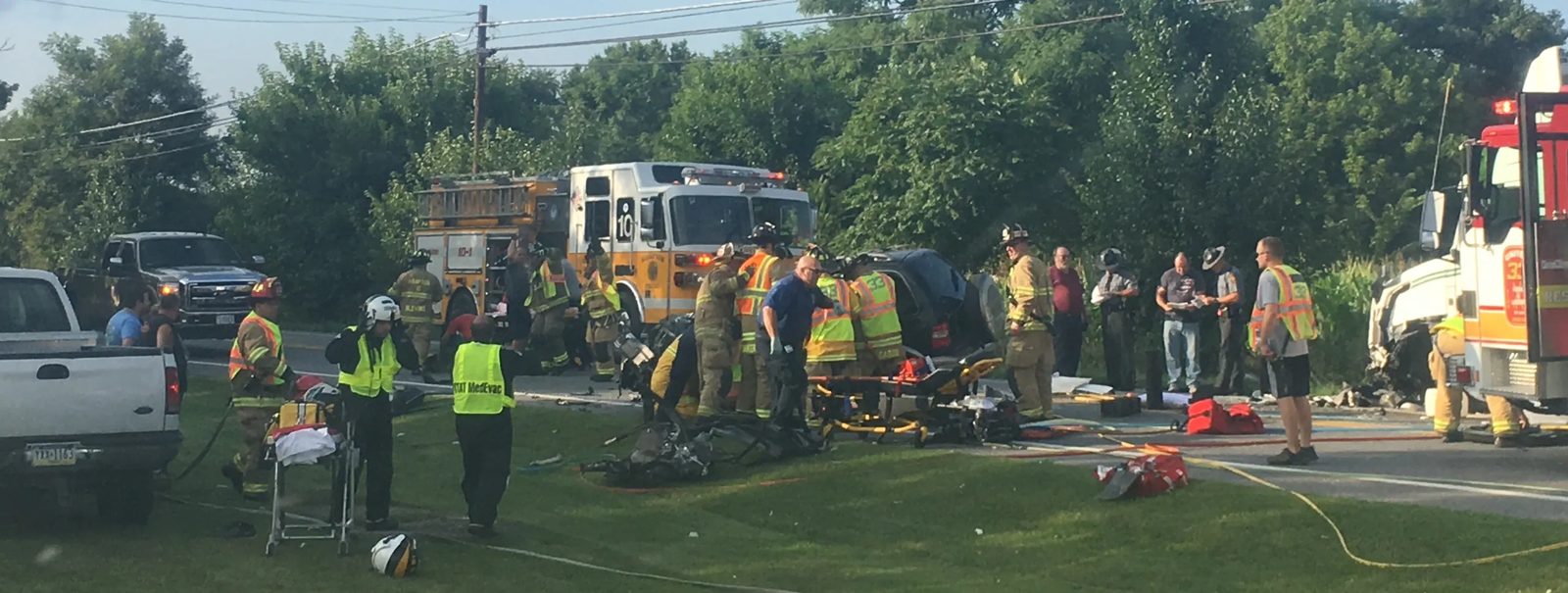 First responders and chaplains working the scene of an accident, extricating a patient and coordinating care.